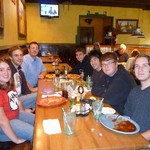 Photo of trombone students around table at dinner during Fall 2009.